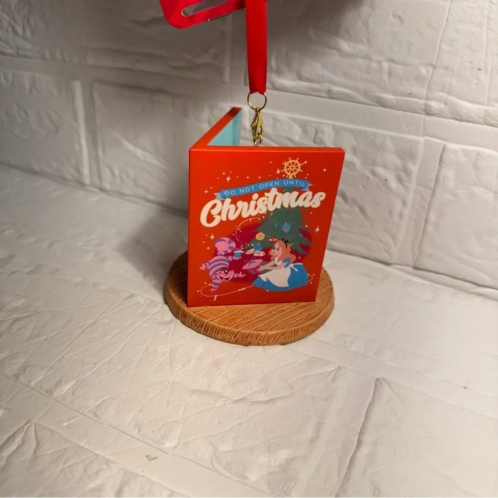 New Disney Cheshire Cat Christmas Ornament in Book Red and Purple